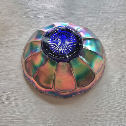 Vintage Fenton carnival glass berry bowl with iridescent rainbow finish and raised grapevine pattern.