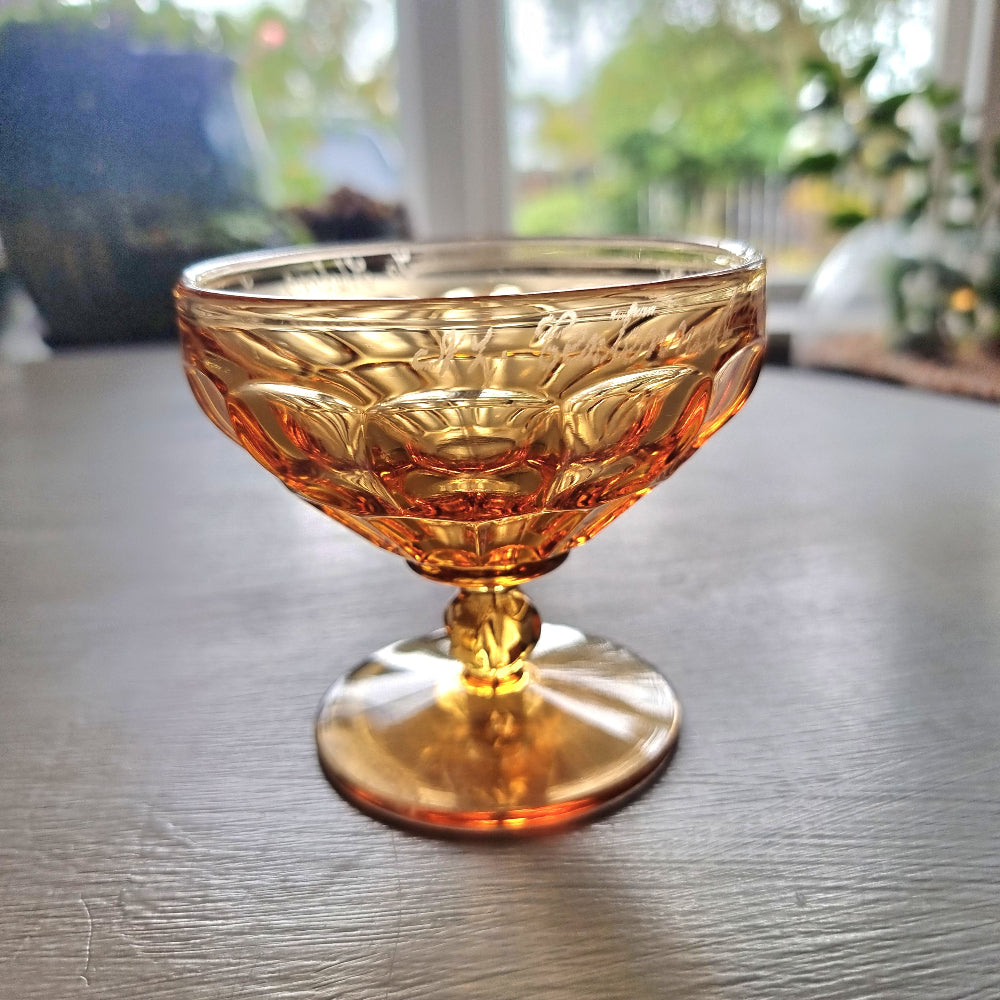 Vintage amber pedestal glass engraved with NZ Centennial Exhibition 1940 inscription and faceted bowl design.