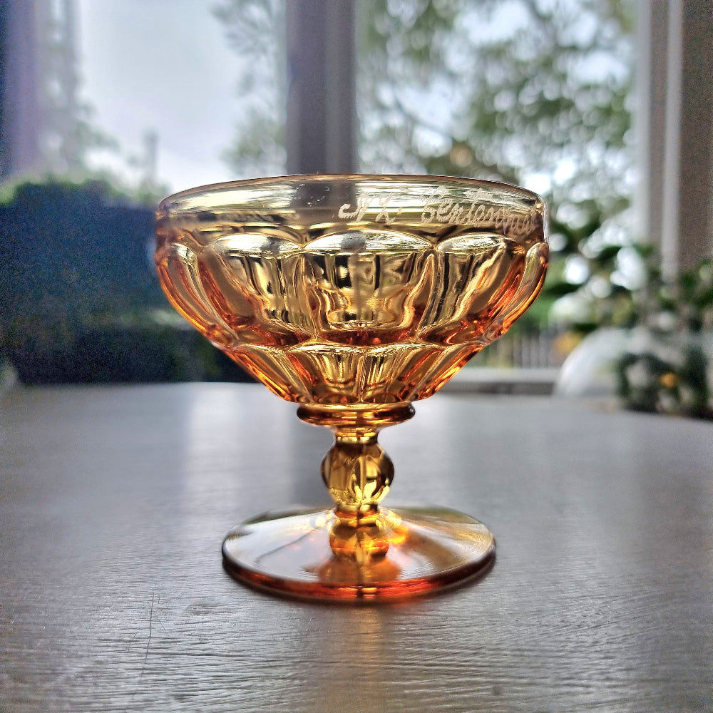 Vintage amber pedestal glass engraved with NZ Centennial Exhibition 1940 inscription and faceted bowl design.