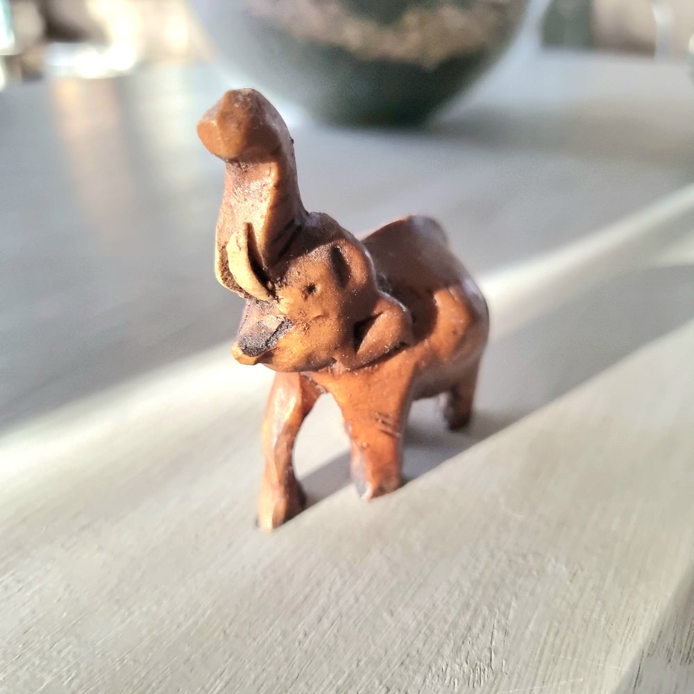 Miniature hand-carved wooden elephant figurine