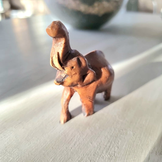 Miniature hand-carved wooden elephant figurine