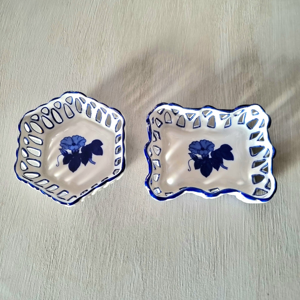Pair of vintage blue and white reticulated porcelain trinket dishes with pierced lattice border and floral motif, one hexagonal and one rectangular