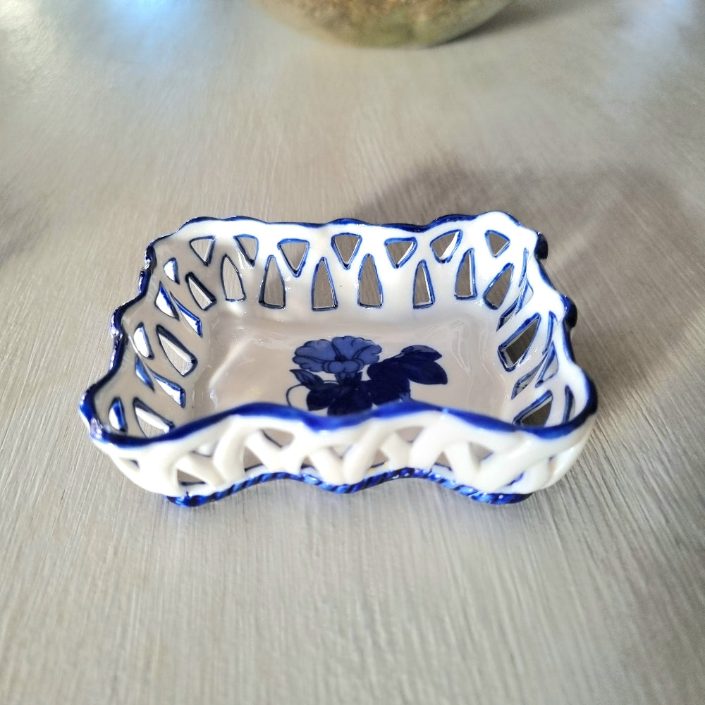 Pair of vintage blue and white reticulated porcelain trinket dishes with pierced lattice border and floral motif, one hexagonal and one rectangular
