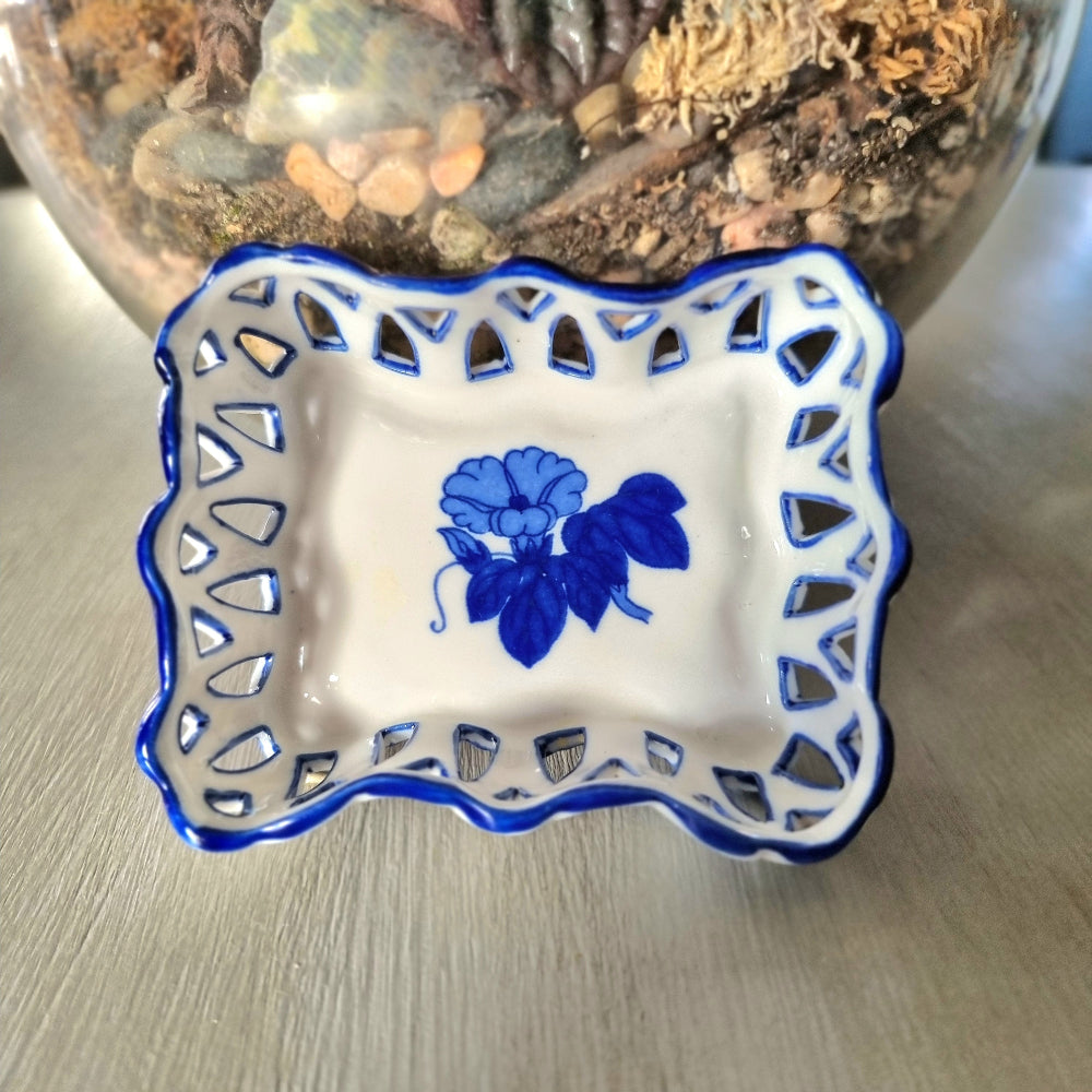 Pair of vintage blue and white reticulated porcelain trinket dishes with pierced lattice border and floral motif, one hexagonal and one rectangular