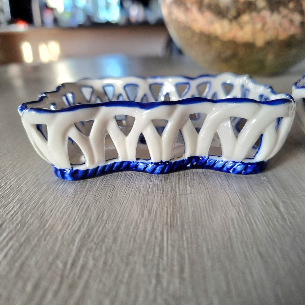 Pair of vintage blue and white reticulated porcelain trinket dishes with pierced lattice border and floral motif, one hexagonal and one rectangular