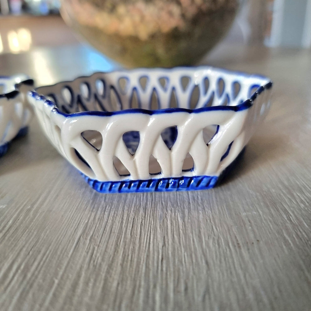 Pair of vintage blue and white reticulated porcelain trinket dishes with pierced lattice border and floral motif, one hexagonal and one rectangular