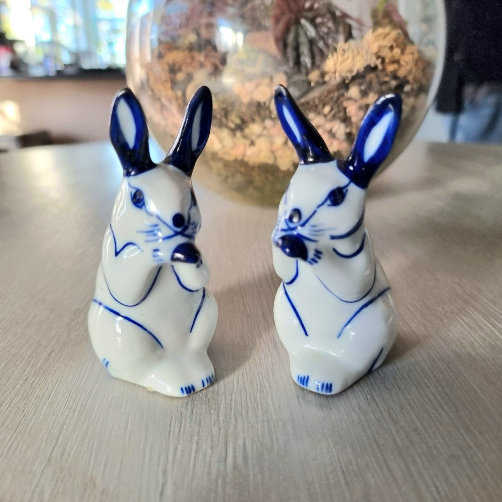 Pair of vintage blue and white porcelain rabbit ornaments with cobalt blue ears and detail, Delft style bunny figurines