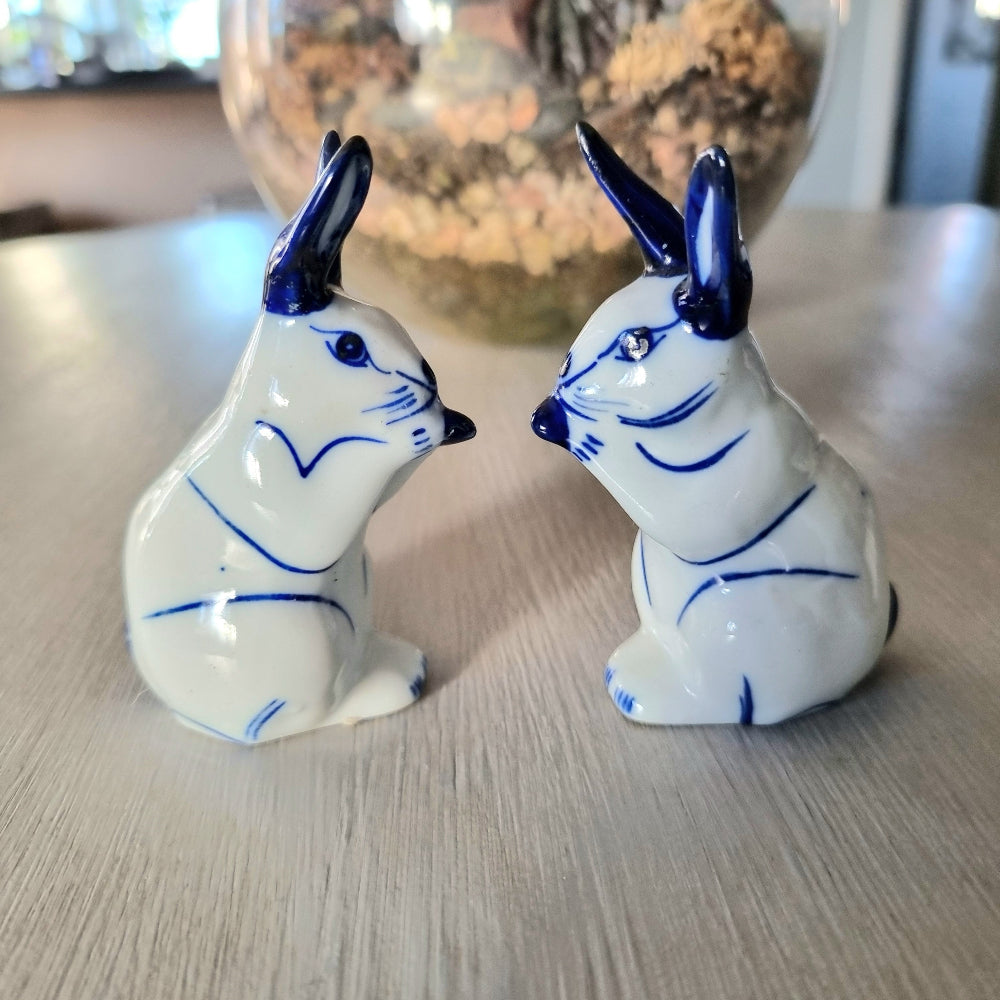 Pair of vintage blue and white porcelain rabbit ornaments with cobalt blue ears and detail, Delft style bunny figurines
