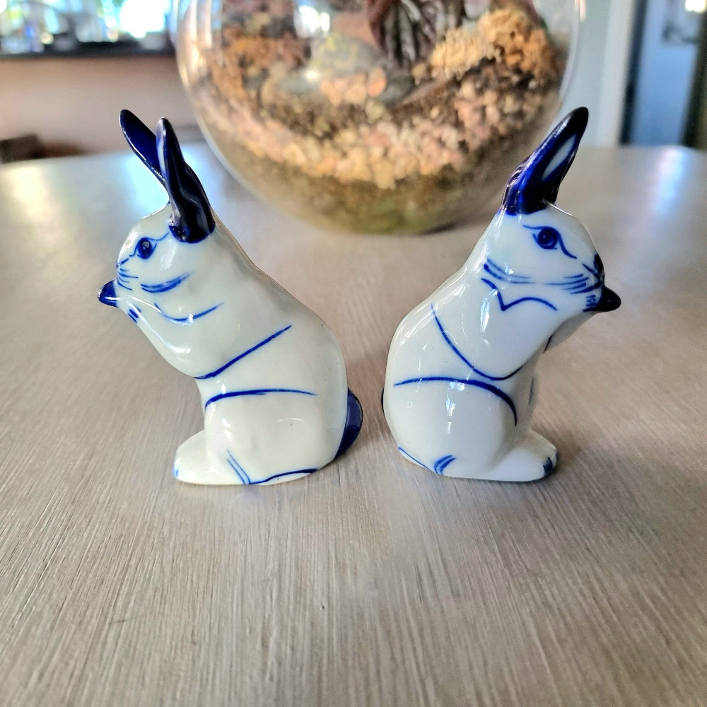 Pair of vintage blue and white porcelain rabbit ornaments with cobalt blue ears and detail, Delft style bunny figurines