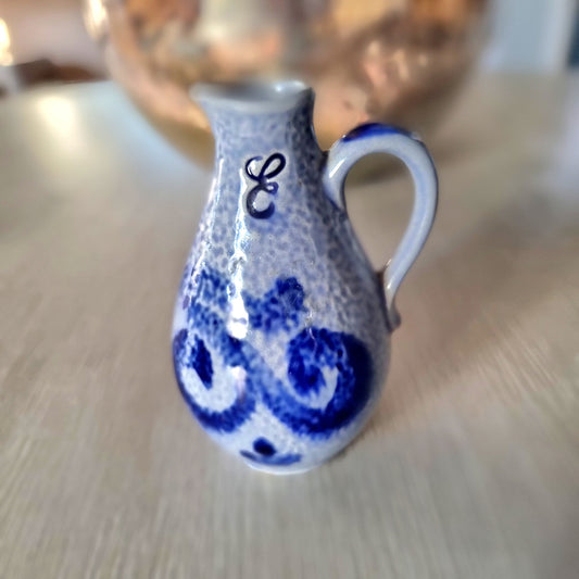 Vintage blue speckle glaze miniature jug with cobalt floral decoration and cursive letter E monogram on neck