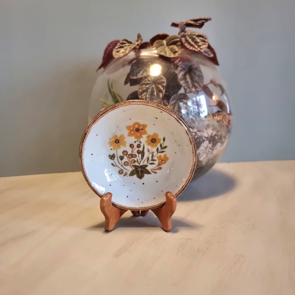 Vintage Johnson Brothers ironstone dish with orange floral bouquet and speckled white background
