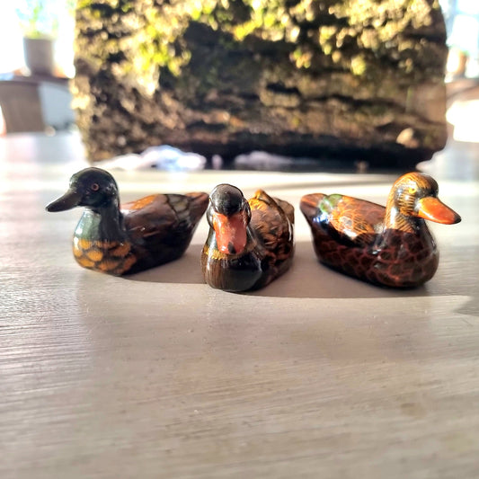 Trio of vintage hand-painted ceramic duck figurines with lustre glaze finish