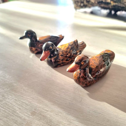 Trio of vintage hand-painted ceramic duck figurines with lustre glaze finish