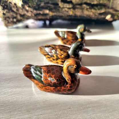 Trio of vintage hand-painted ceramic duck figurines with lustre glaze finish