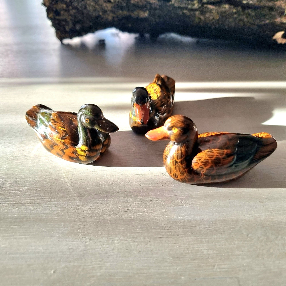 Trio of vintage hand-painted ceramic duck figurines with lustre glaze finish