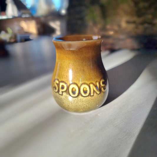 Vintage honey glaze "Spoons" jar with embossed lettering and small glaze chip