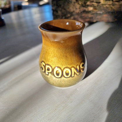 Vintage honey glaze "Spoons" jar with embossed lettering and small glaze chip