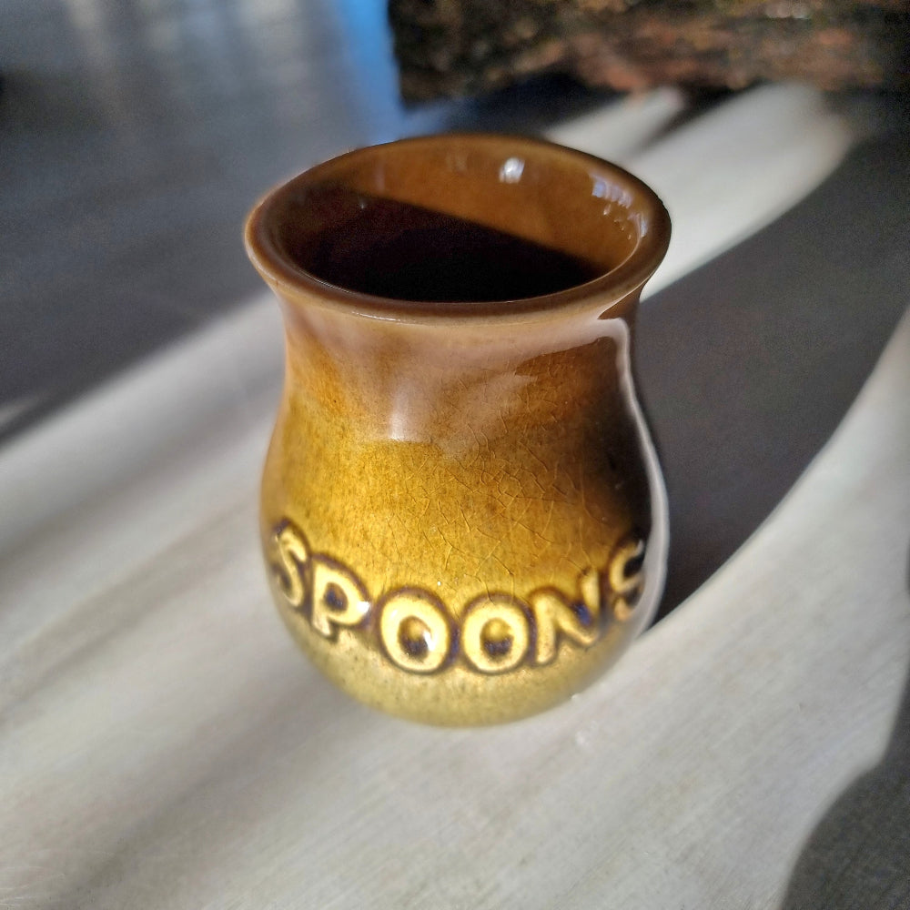 Vintage honey glaze "Spoons" jar with embossed lettering and small glaze chip