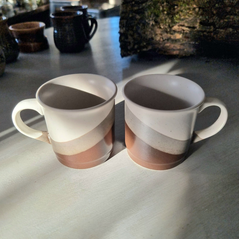 Pair of retro mugs with white, grey and terracotta diagonal colour block design