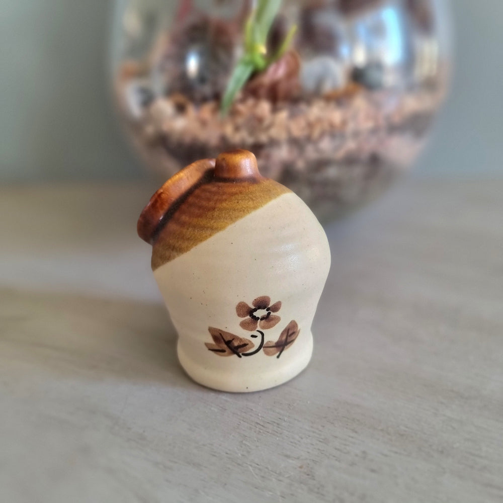 Vintage cottage-style ceramic salt pig or honey pot with brown glaze and hand-painted floral design