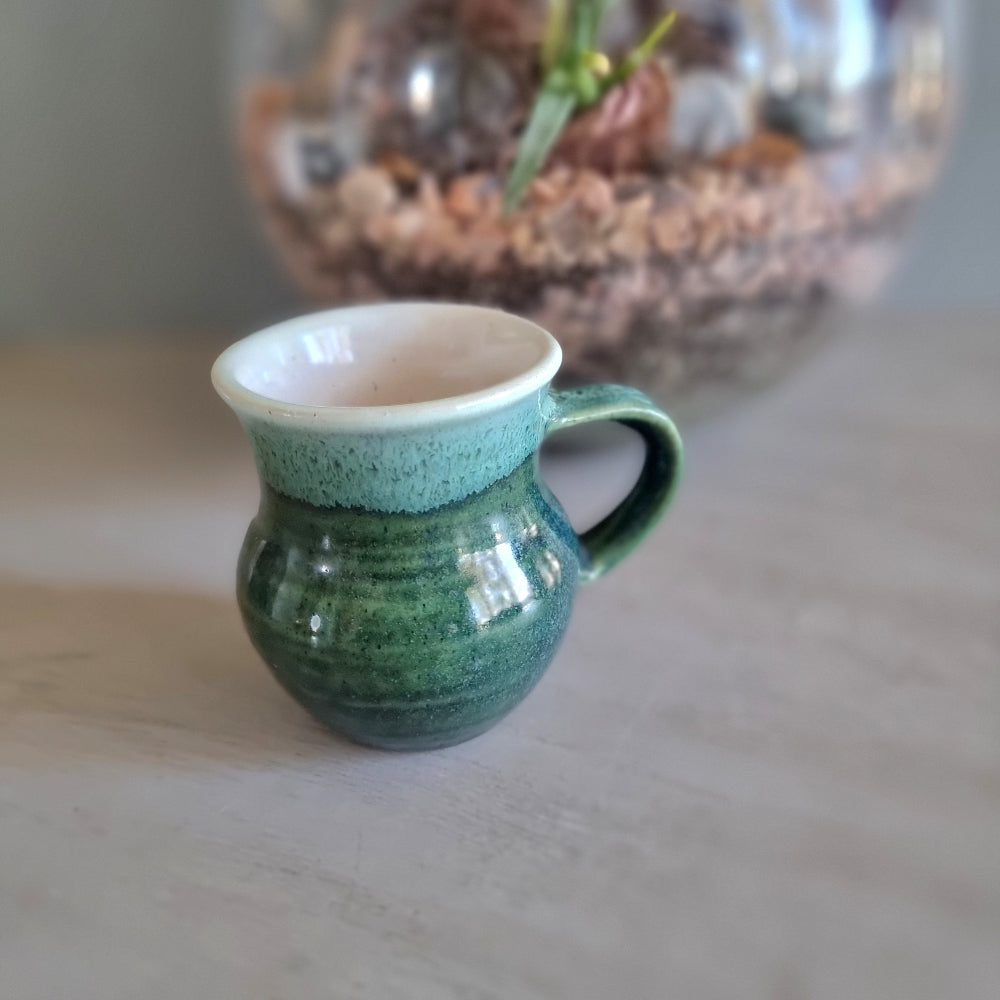 Vintage green studio pottery mug with cream rim and handle