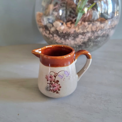 Vintage cream jug with brown glazed rim and pink floral design