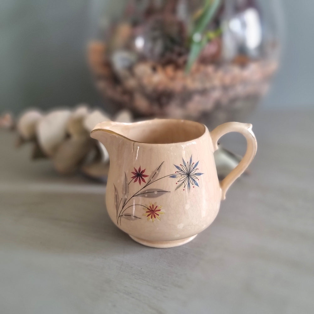 Vintage Crown Lynn New Zealand creamer jug with hand-painted starburst floral design