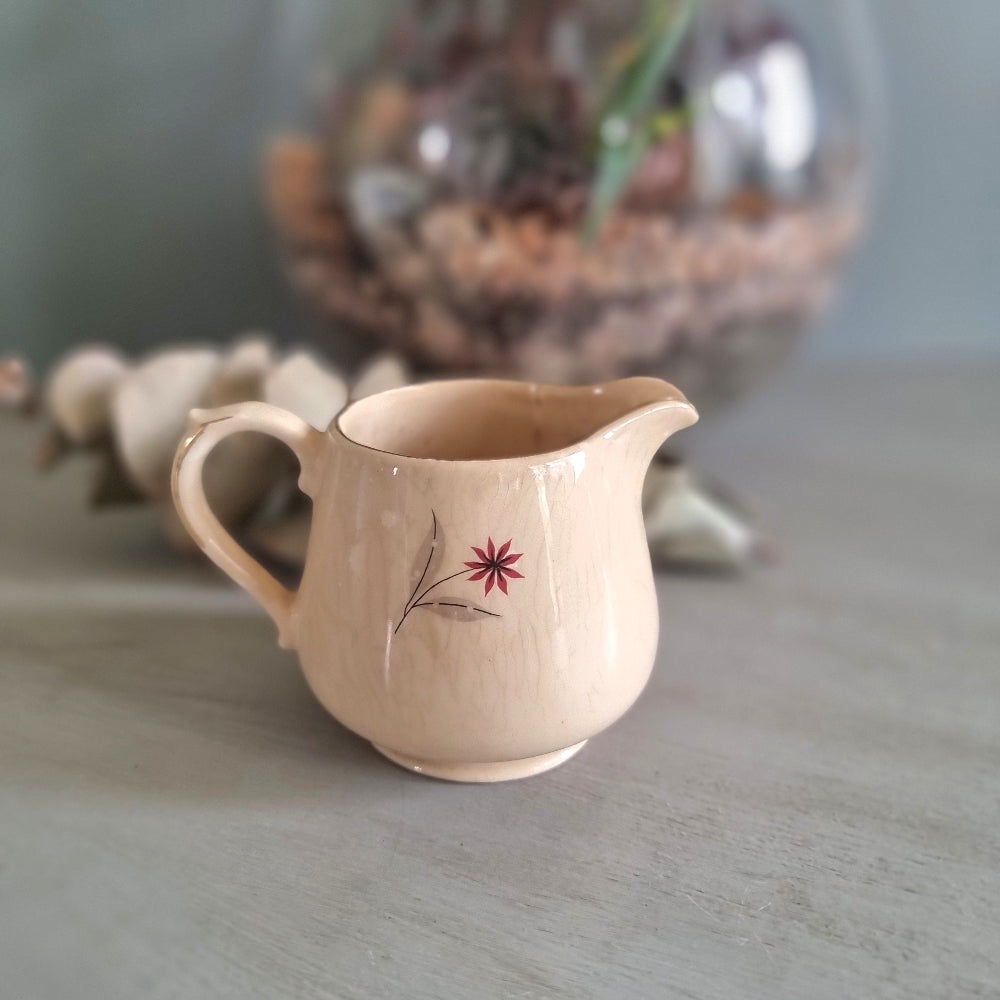 Vintage Crown Lynn New Zealand creamer jug with hand-painted starburst floral design