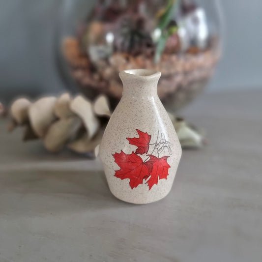Vintage speckled cream ceramic jug with red maple leaf design