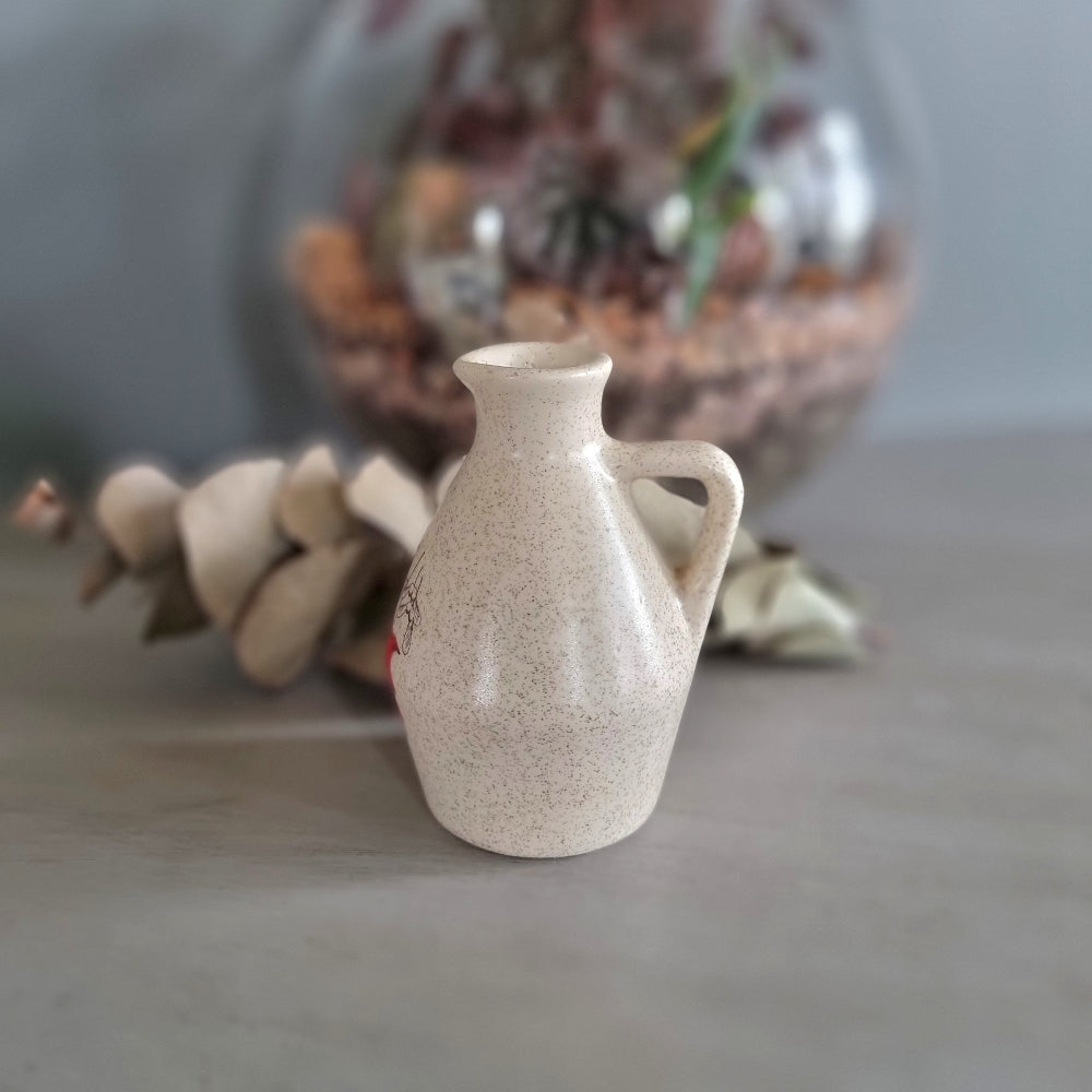 Vintage speckled cream ceramic jug with red maple leaf design