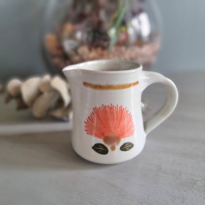 Vintage Kathy Palenski NZ studio pottery creamer jug with pōhutukawa flower design
