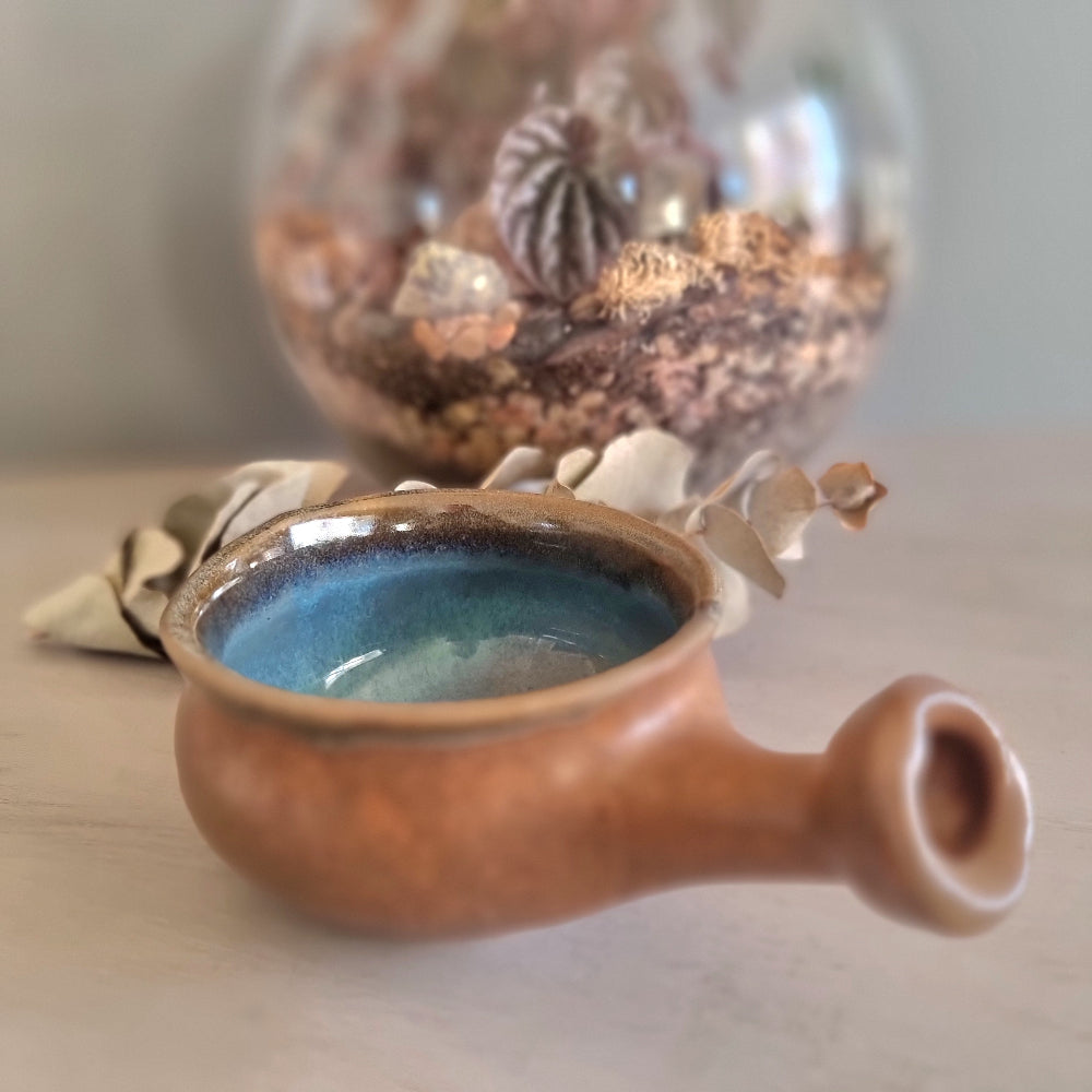 Handmade ceramic bowl with terracotta exterior and blue glaze interior
