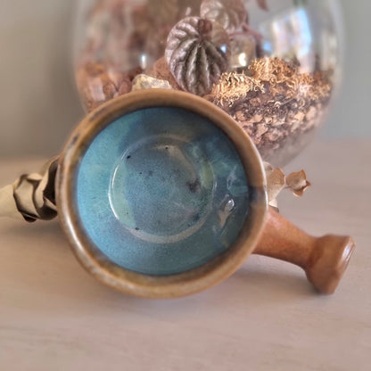 Handmade ceramic bowl with terracotta exterior and blue glaze interior
