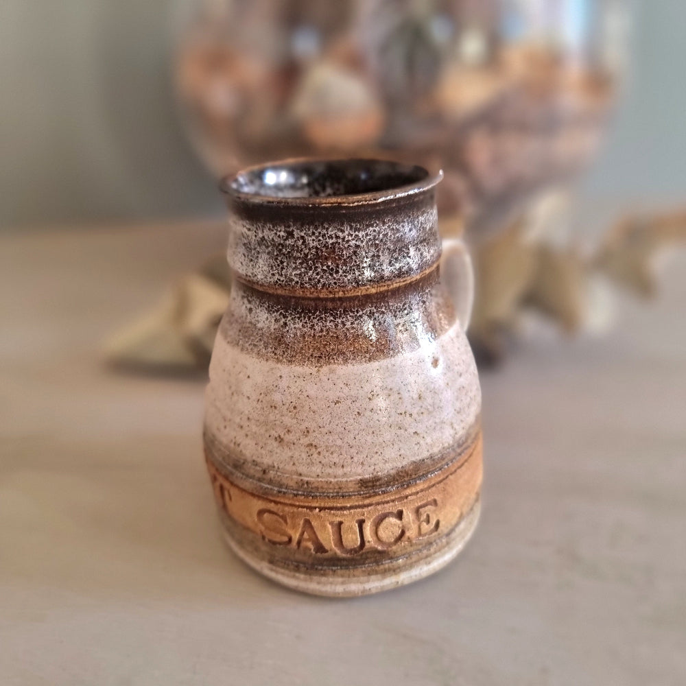 Vintage stoneware mint sauce jug with handle and brown drip glaze