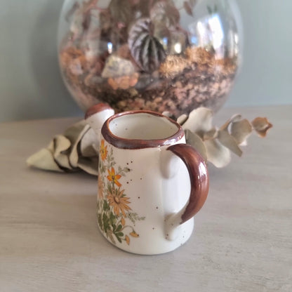 Vintage floral ceramic watering can made in Japan with orange daisy design