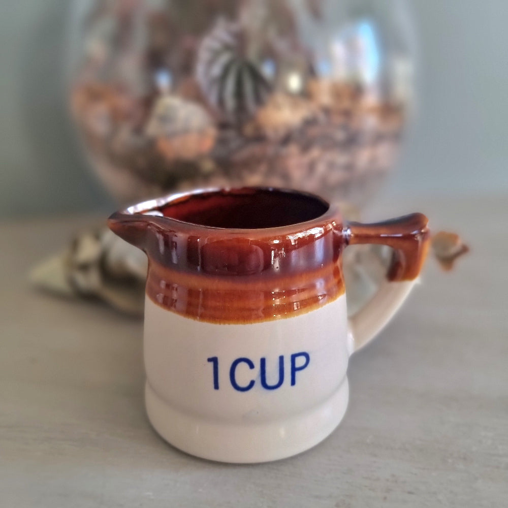 Vintage ceramic measuring jug set with brown drip glaze, three jugs