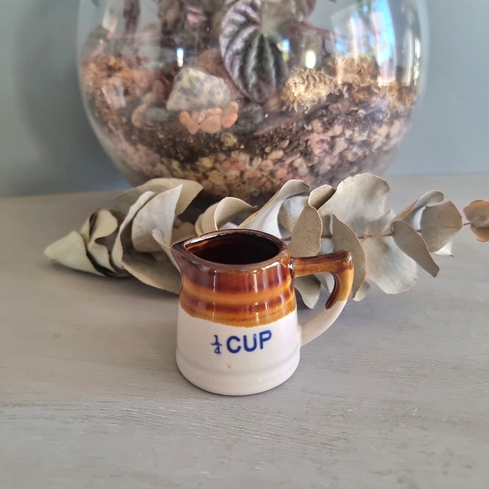 Vintage ceramic measuring jug set with brown drip glaze, three jugs