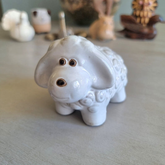 Glossy white ceramic sheep figurine with swirled wool texture