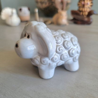 Glossy white ceramic sheep figurine with swirled wool texture