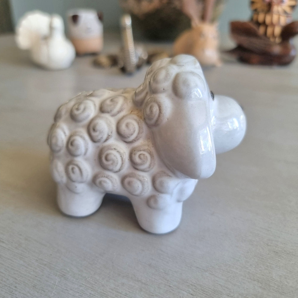 Glossy white ceramic sheep figurine with swirled wool texture