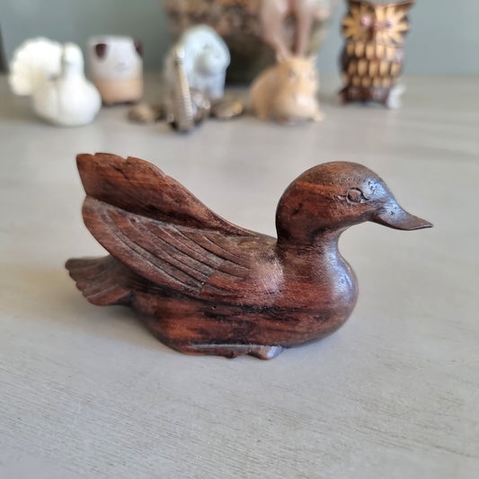 Hand carved wooden duck figurine with feathered wing detail