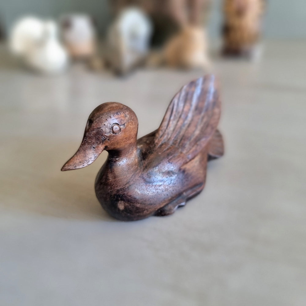 Hand carved wooden duck figurine with feathered wing detail