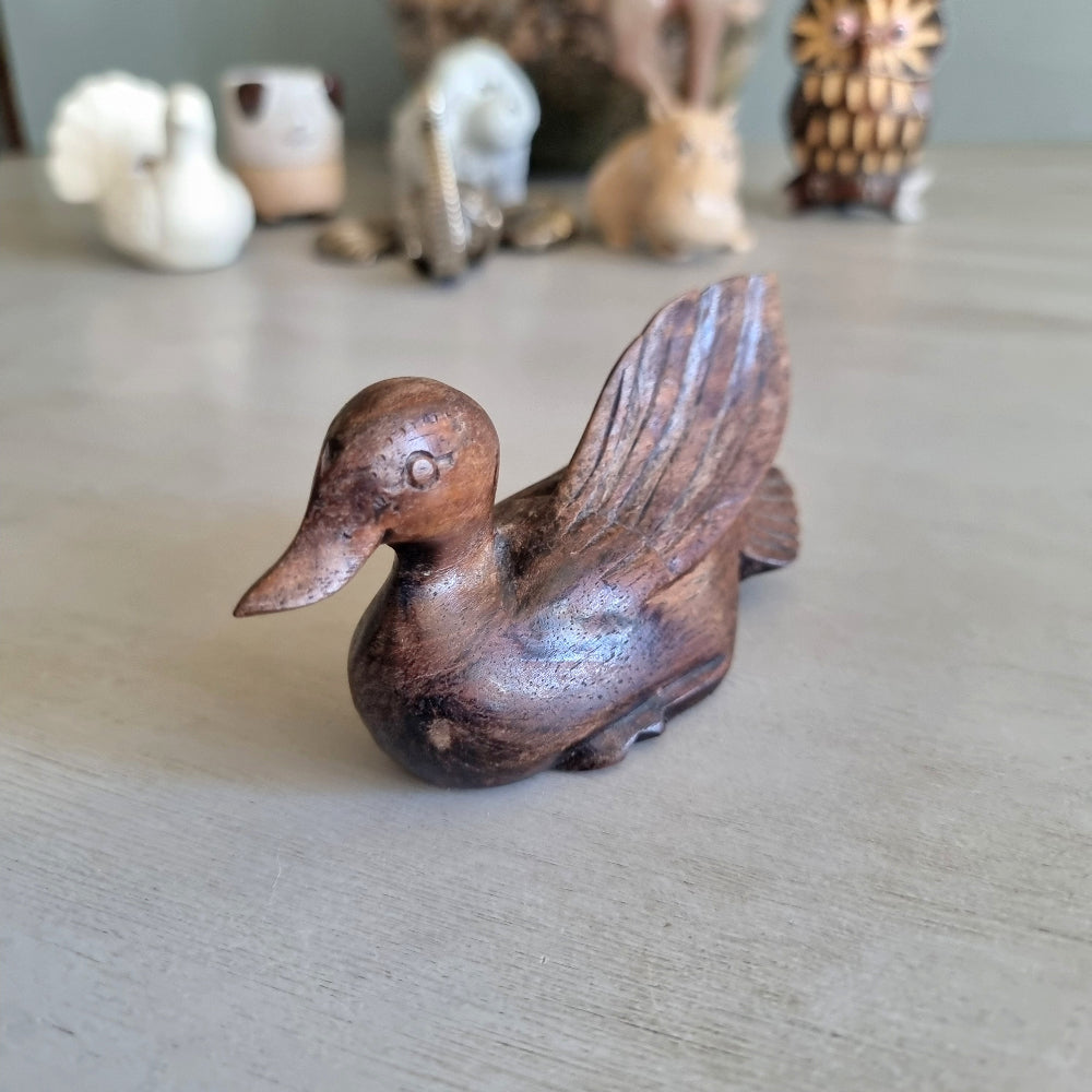 Hand carved wooden duck figurine with feathered wing detail