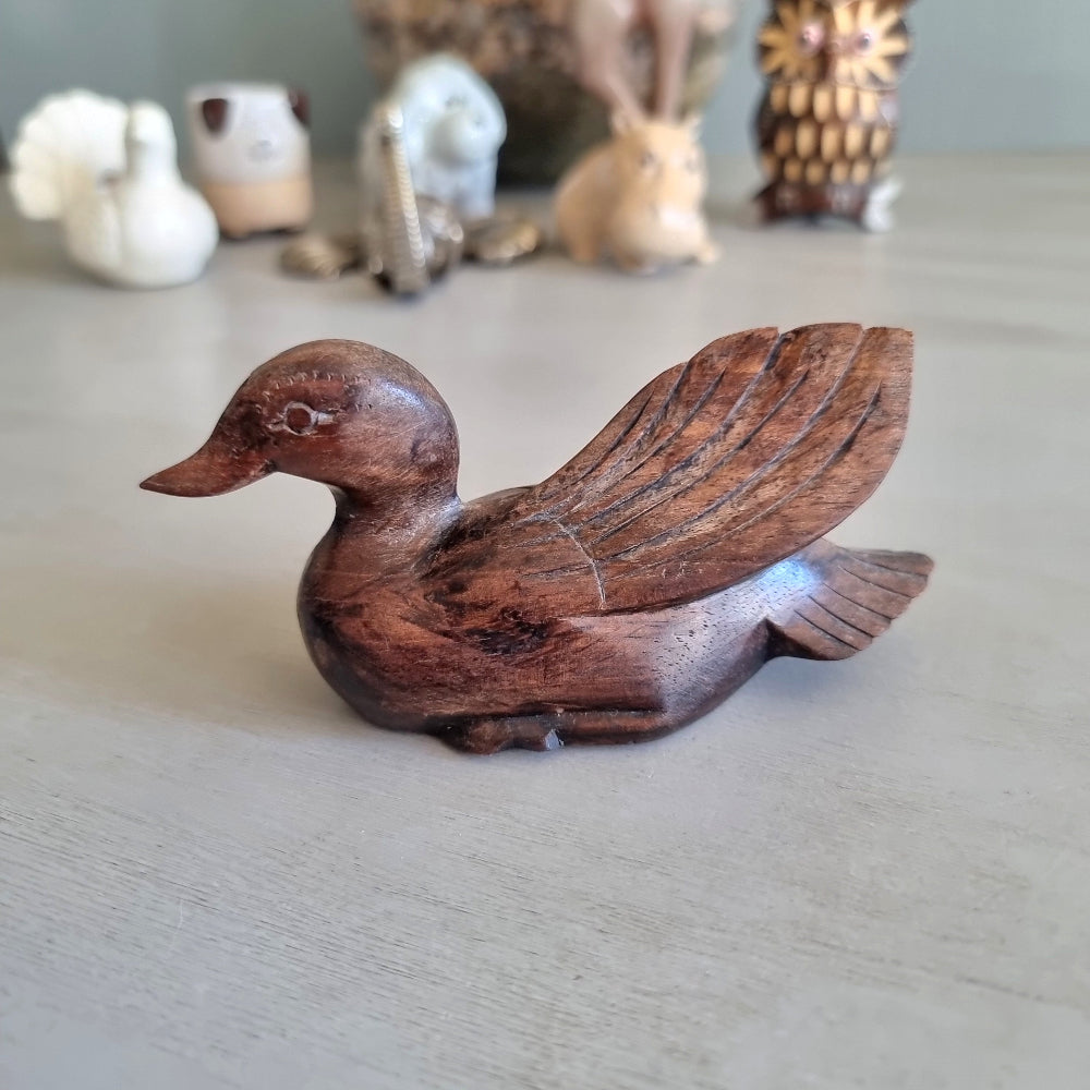 Hand carved wooden duck figurine with feathered wing detail