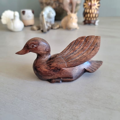 Hand carved wooden duck figurine with feathered wing detail