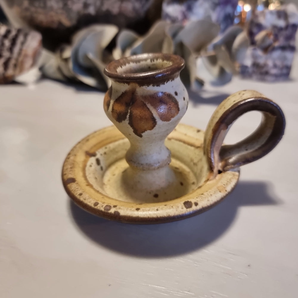 Handmade ceramic chamberstick candle holder by Ralph Hetzel, Sunshine Pottery Nelson. Cream glaze with brown drip detailing, stamped maker's mark to base.