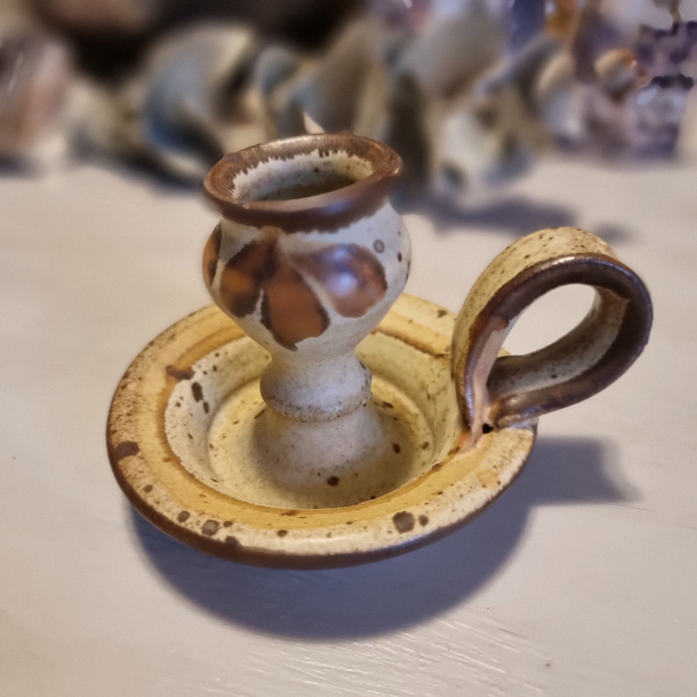 Handmade ceramic chamberstick candle holder by Ralph Hetzel, Sunshine Pottery Nelson. Cream glaze with brown drip detailing, stamped maker's mark to base.