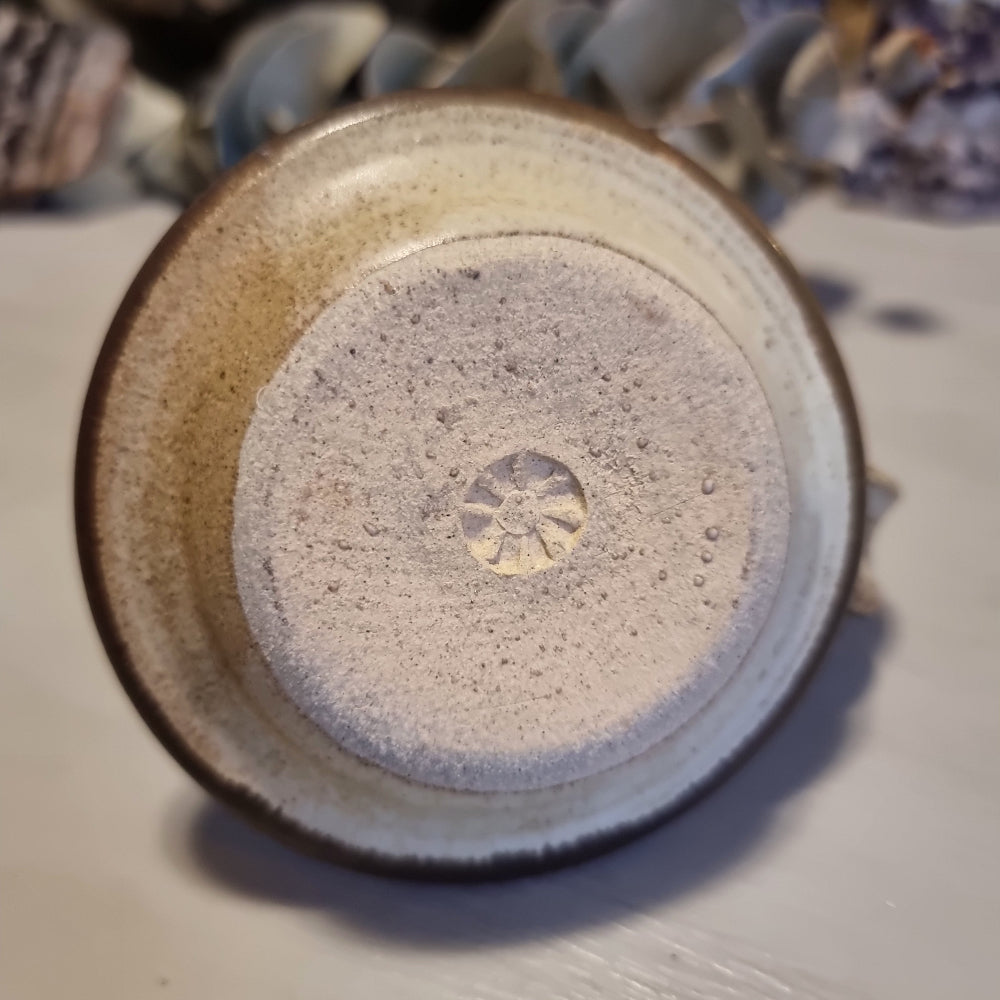 Handmade ceramic chamberstick candle holder by Ralph Hetzel, Sunshine Pottery Nelson. Cream glaze with brown drip detailing, stamped maker's mark to base.