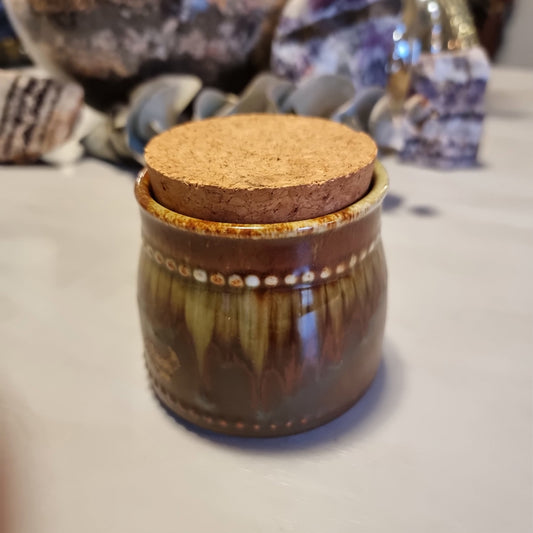 Small vintage stoneware jar in Country Fair style with beaded dot border and brown to olive drip glaze, with original cork lid