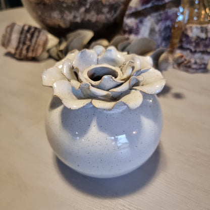 Sculptural ceramic bud vase with rose-shaped petal rim in cream glaze and speckled blue-grey body